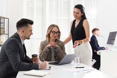 Photo of Marketing. Team of businesspeople working together at desk in office