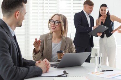 Photo of Marketing. Businesspeople working together in office, selective focus