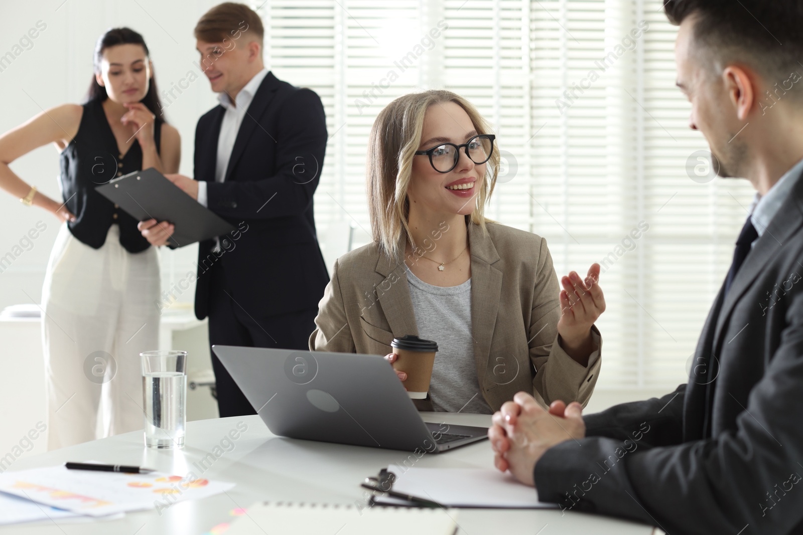 Marketing. Businesspeople working together in office, selective focus Photo of Marketing. Businesspeople working together in office, selective focus