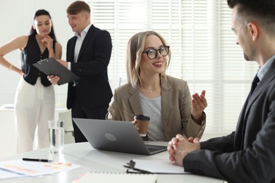 Photo of Marketing. Businesspeople working together in office, selective focus