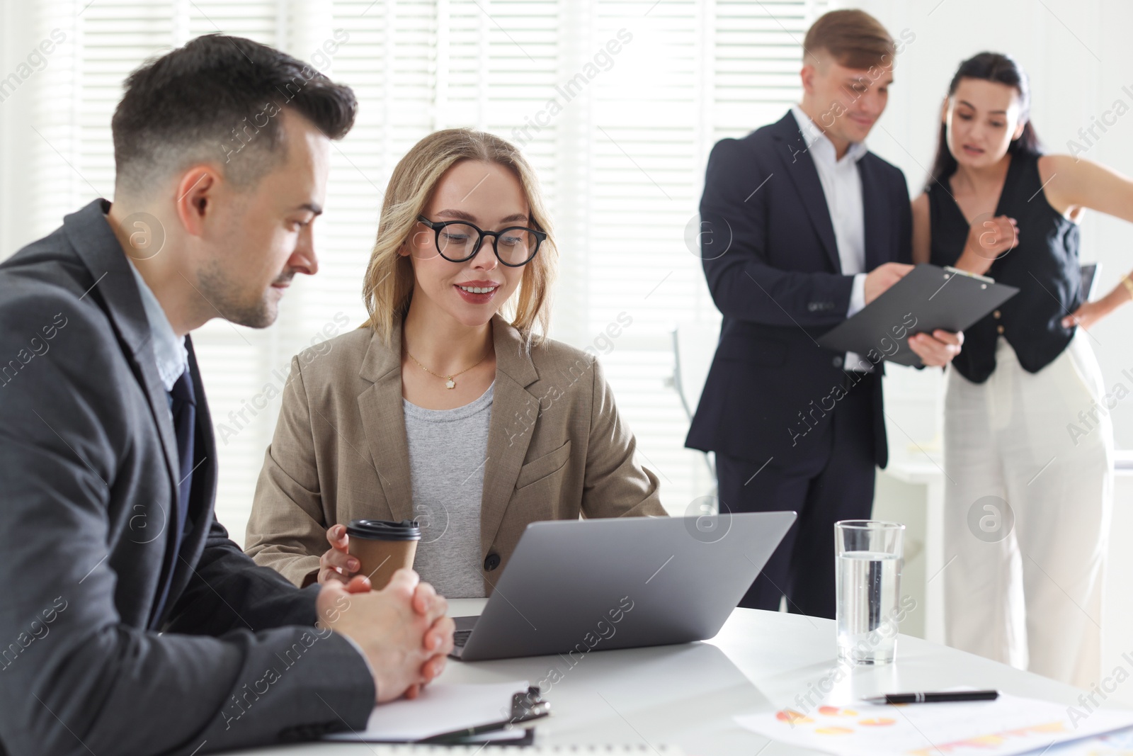 Marketing. Businesspeople working together in office, selective focus Photo of Marketing. Businesspeople working together in office, selective focus