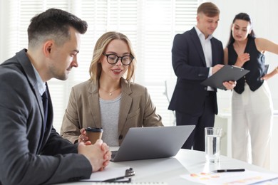 Photo of Marketing. Businesspeople working together in office, selective focus