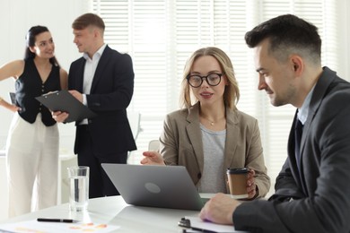 Photo of Marketing. Businesspeople working together in office, selective focus