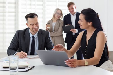 Photo of Marketing. Businesspeople working together in office, selective focus