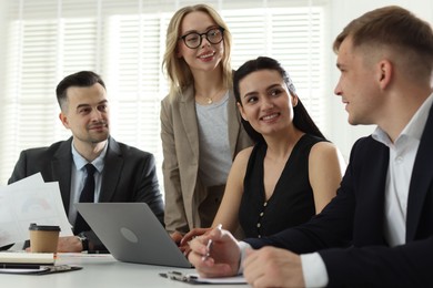 Photo of Marketing. Team of businesspeople working together at desk in office