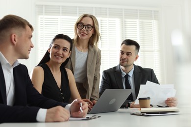 Photo of Marketing. Team of businesspeople working together at desk in office