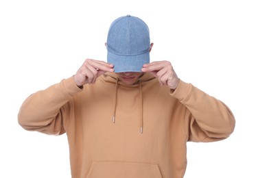 Photo of Young man wearing stylish denim baseball hat on white background
