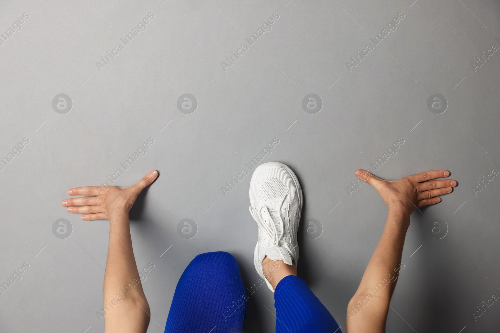 Runner in starting position on gray background, top view. Space for text Photo of Runner in starting position on gray background, top view. Space for text