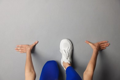 Photo of Runner in starting position on gray background, top view. Space for text