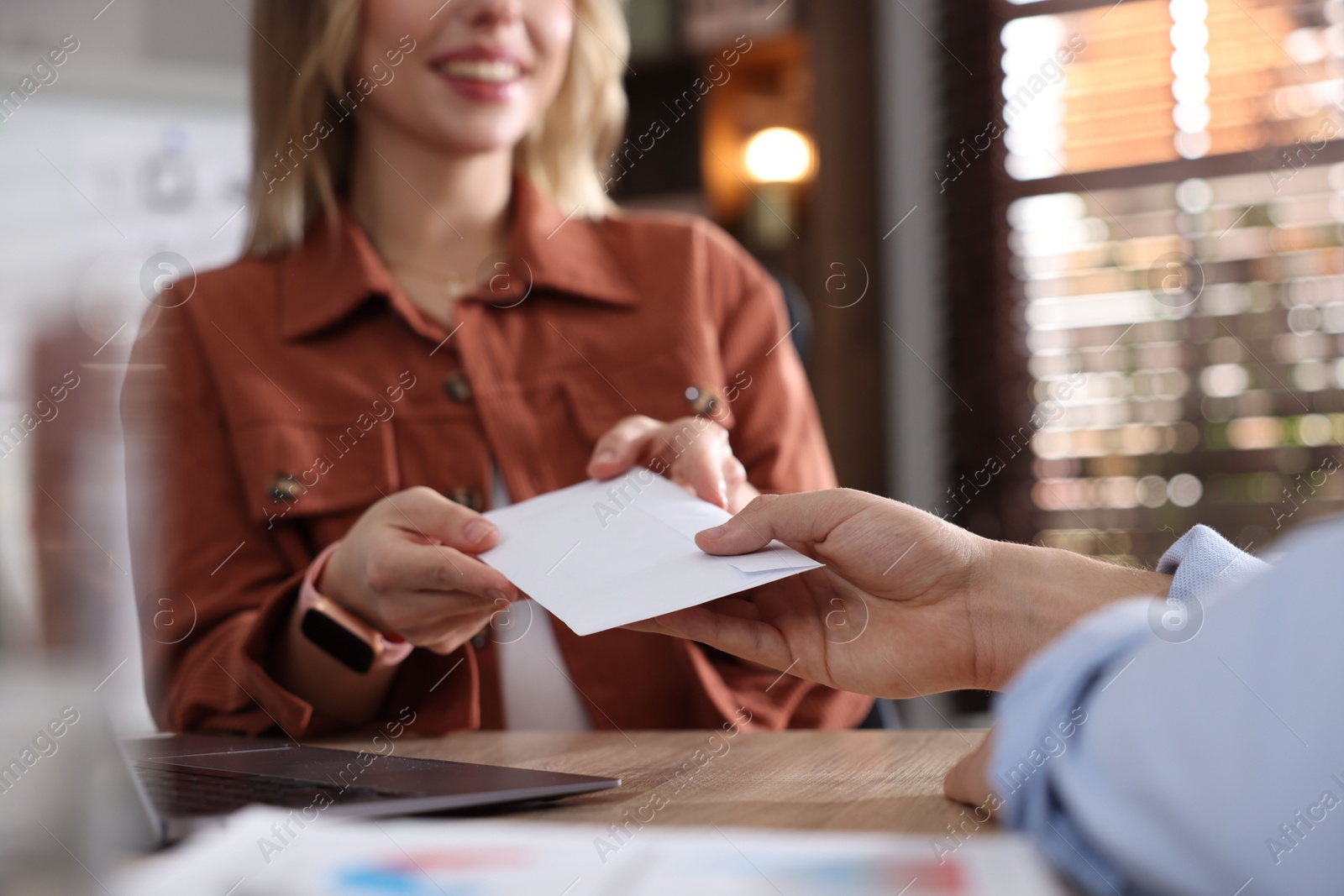 Money bonus. Employee receiving envelope from boss in office, closeup Photo of Money bonus. Employee receiving envelope from boss in office, closeup
