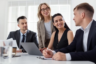 Photo of Marketing. Team of businesspeople working together at desk in office