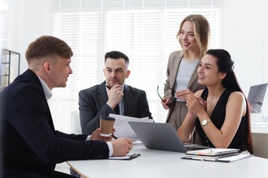 Photo of Marketing. Team of businesspeople working together at desk in office