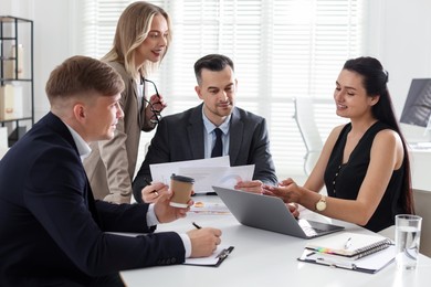 Photo of Marketing. Team of businesspeople working together at desk in office