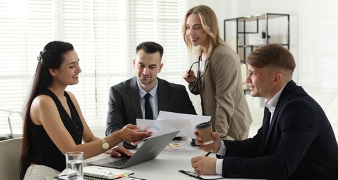 Photo of Marketing. Team of businesspeople working together at desk in office