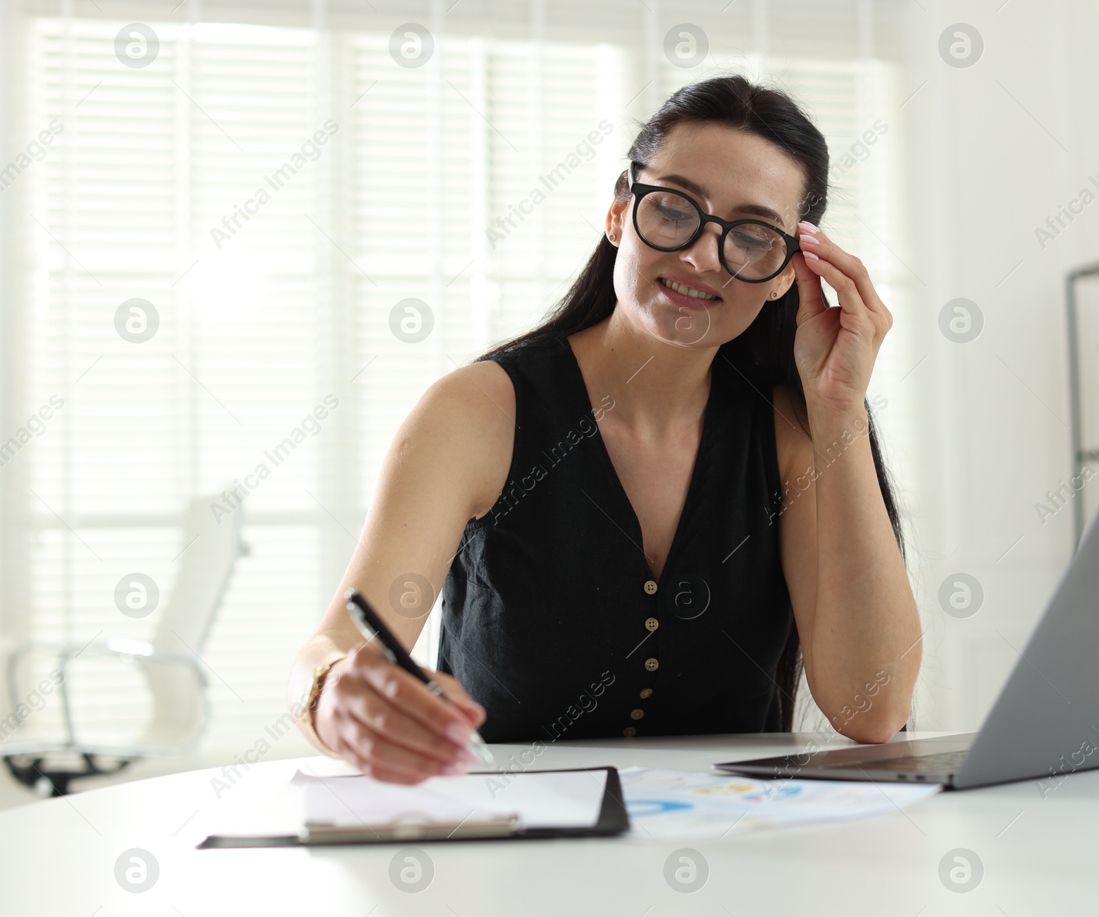 Marketing. Woman working at desk in office Photo of Marketing. Woman working at desk in office