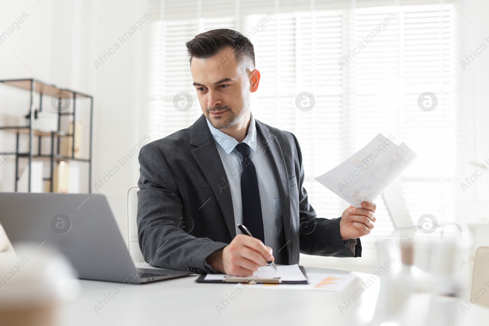 Marketing. Man working at desk in office Photo of Marketing. Man working at desk in office