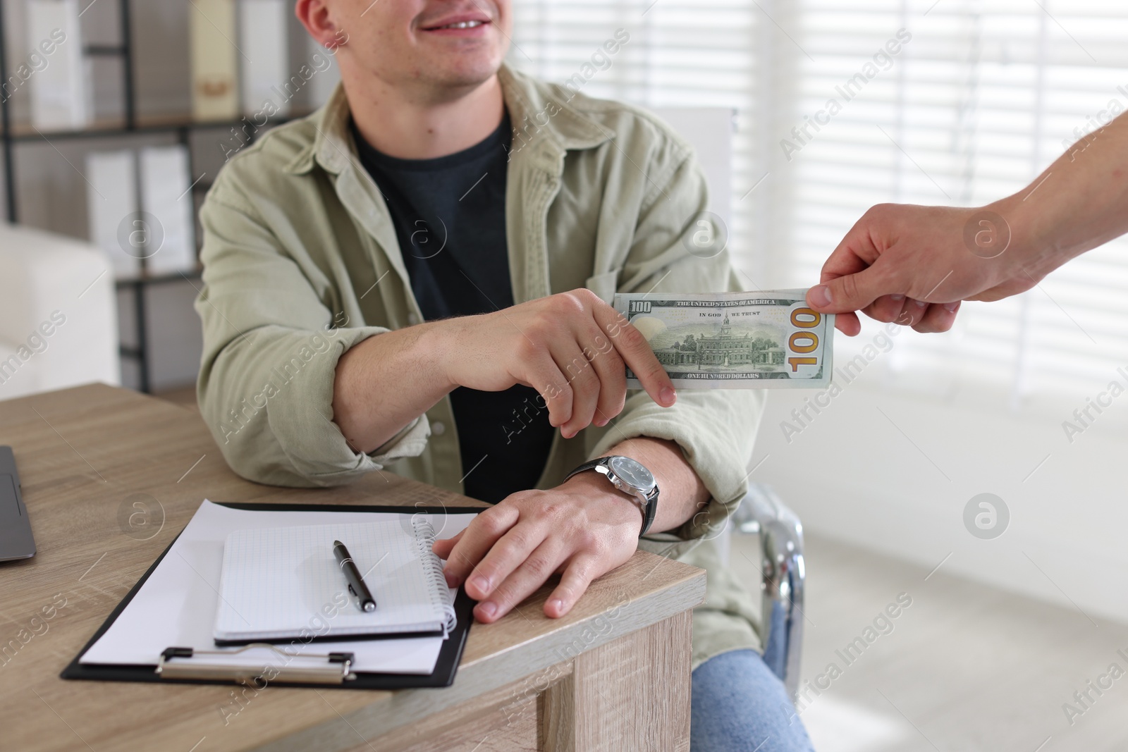 Bonus. Employee receiving money from boss in office, closeup Photo of Bonus. Employee receiving money from boss in office, closeup