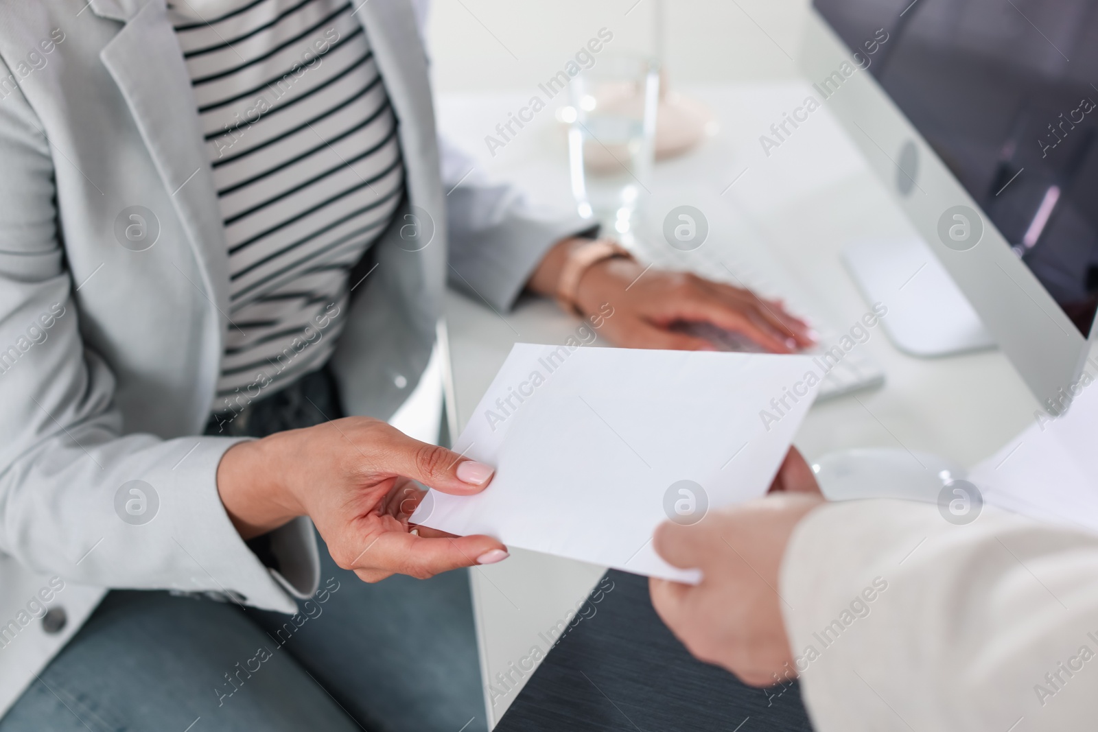 Money bonus. Employee receiving envelope from boss in office, closeup Photo of Money bonus. Employee receiving envelope from boss in office, closeup