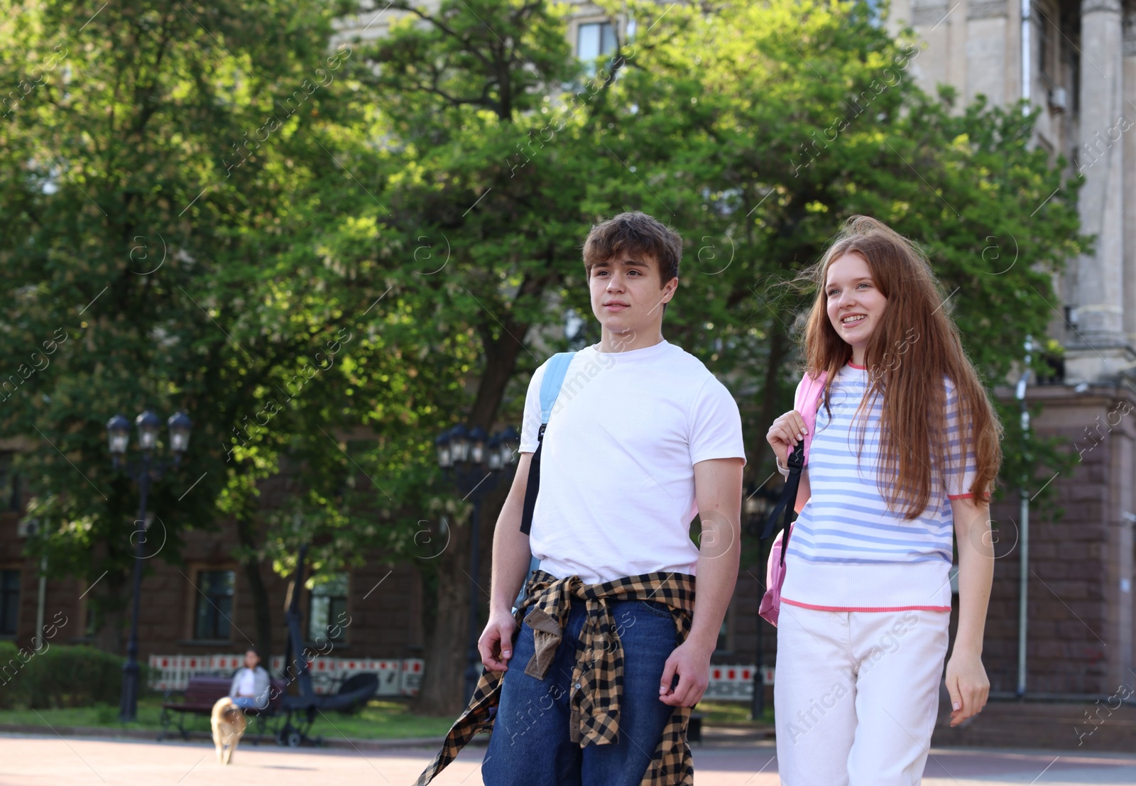 Teenage girl and boy walking together outdoors Photo of Teenage girl and boy walking together outdoors