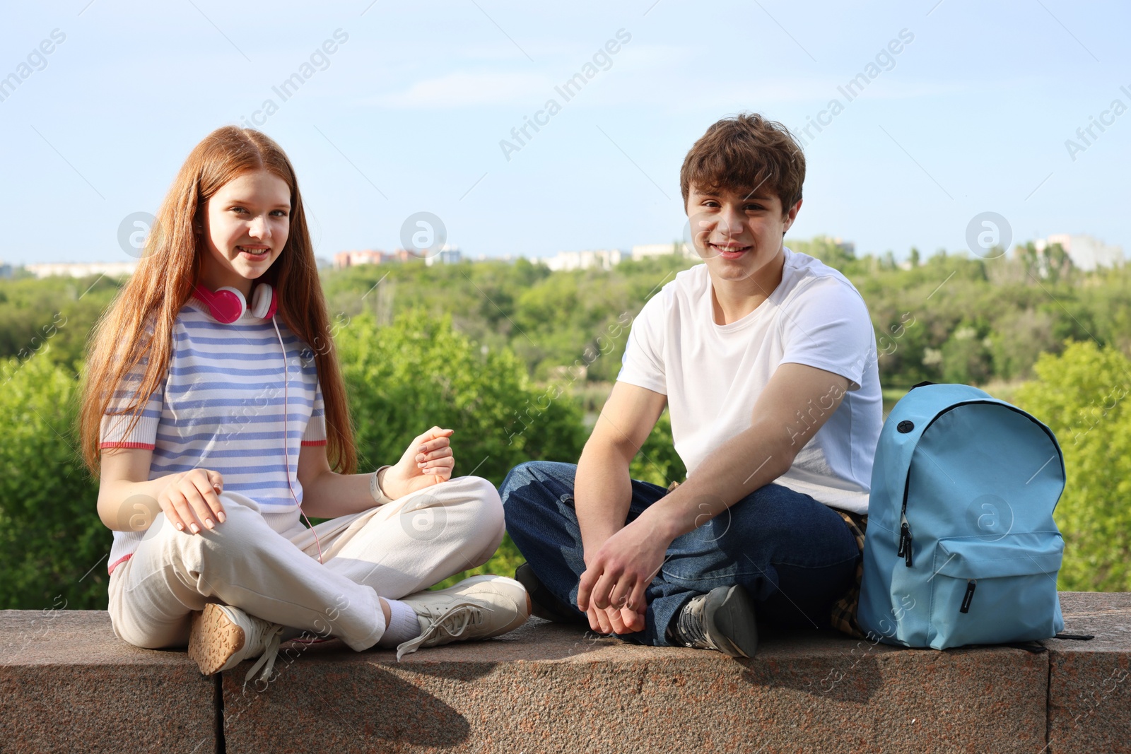 Teenage girl and boy spending time together outdoors Photo of Teenage girl and boy spending time together outdoors