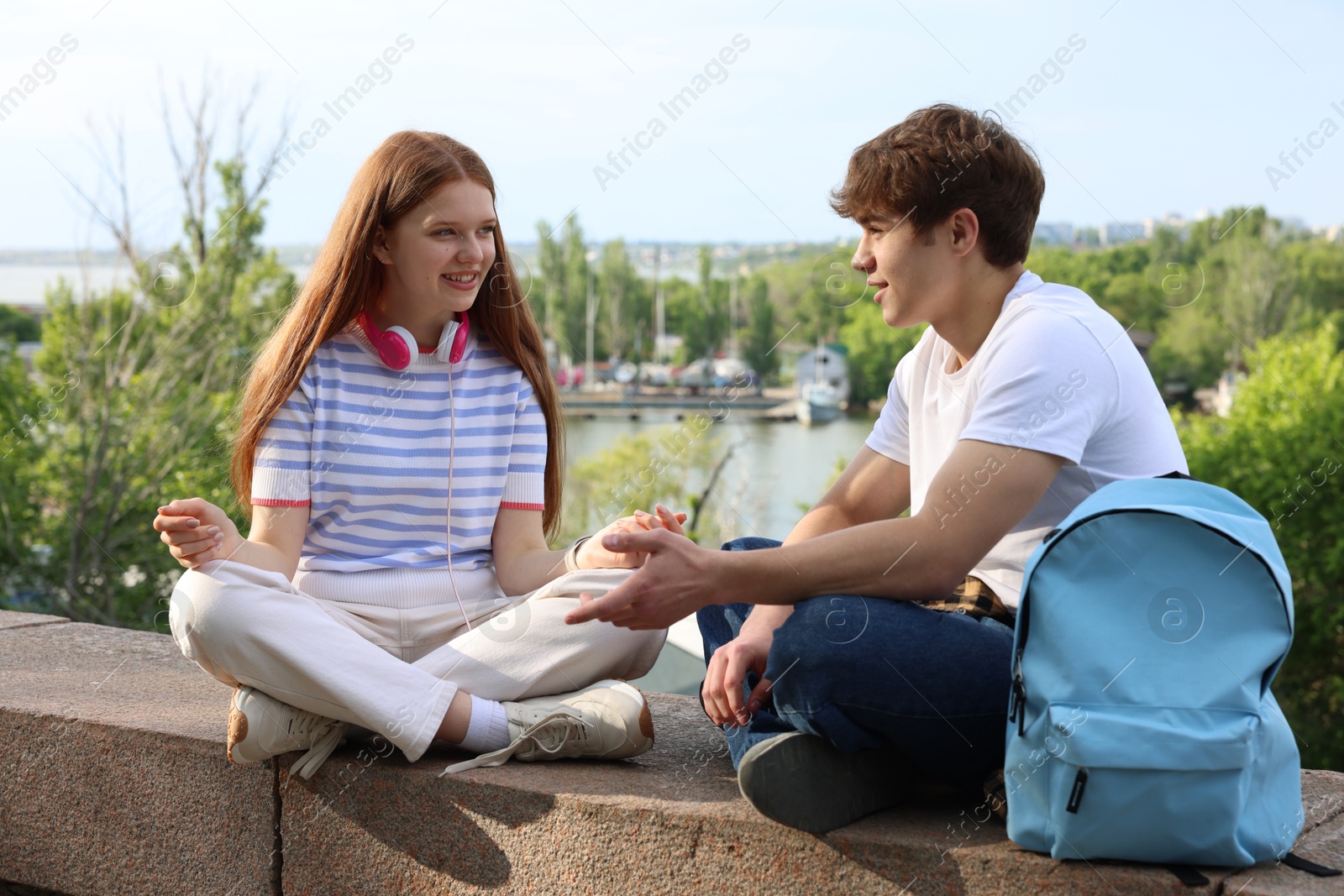 Teenage girl and boy spending time together outdoors Photo of Teenage girl and boy spending time together outdoors