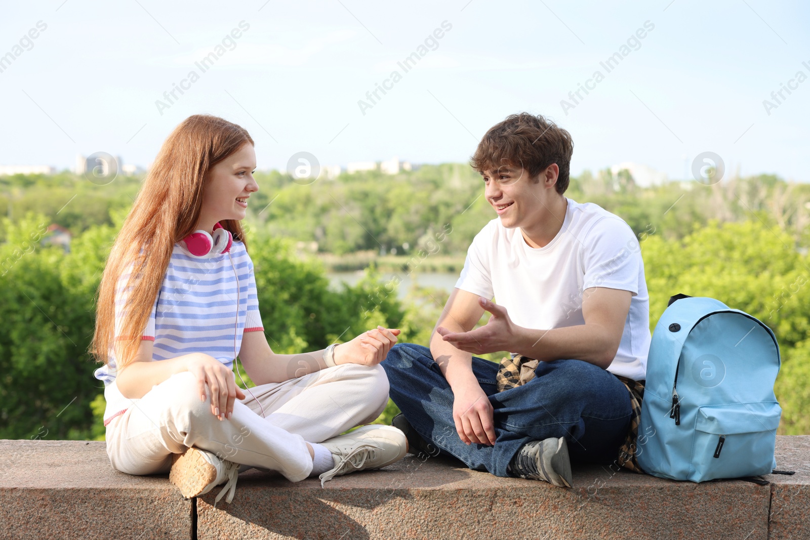 Teenage girl and boy spending time together outdoors Photo of Teenage girl and boy spending time together outdoors