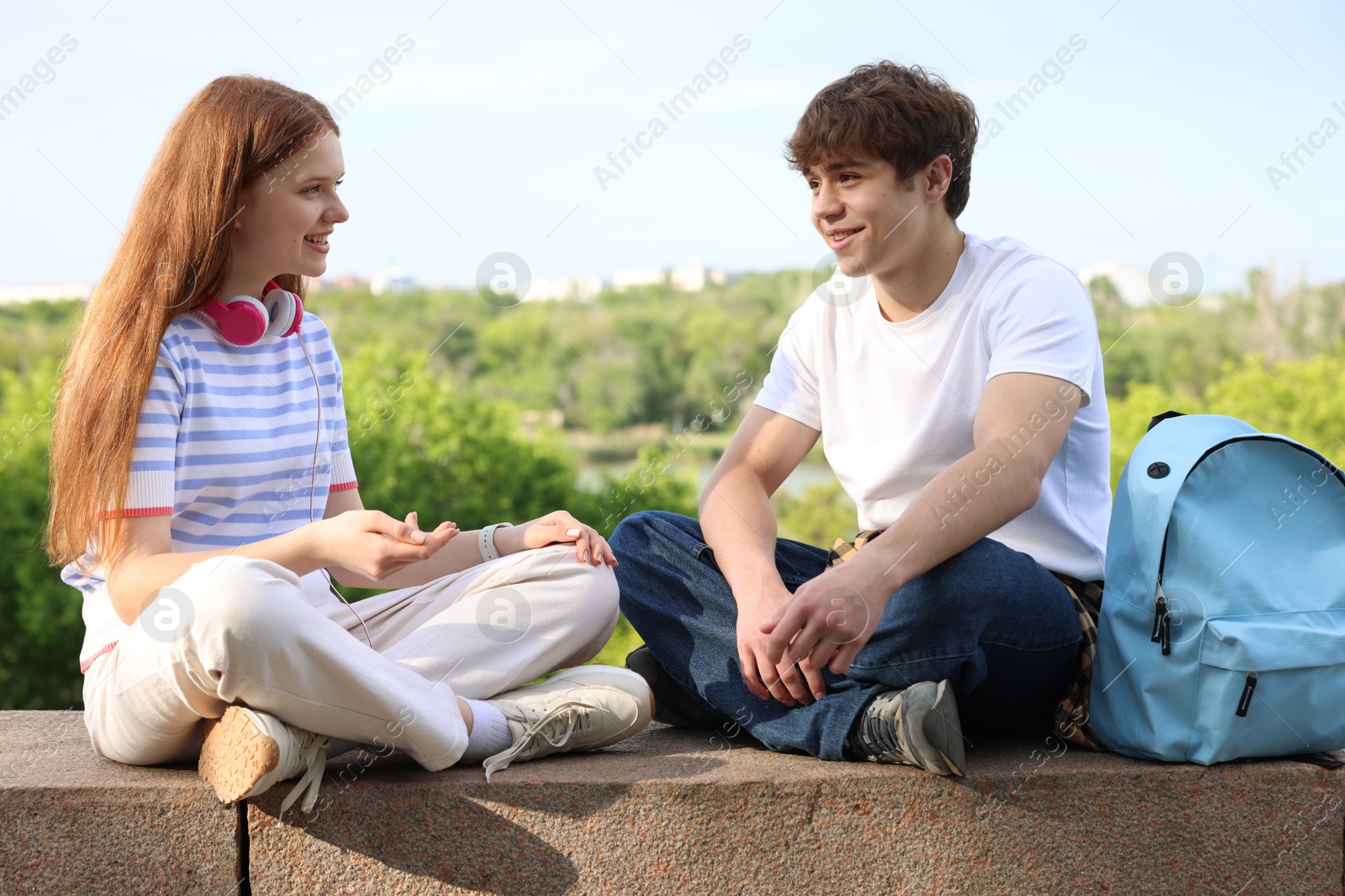 Teenage girl and boy spending time together outdoors Photo of Teenage girl and boy spending time together outdoors
