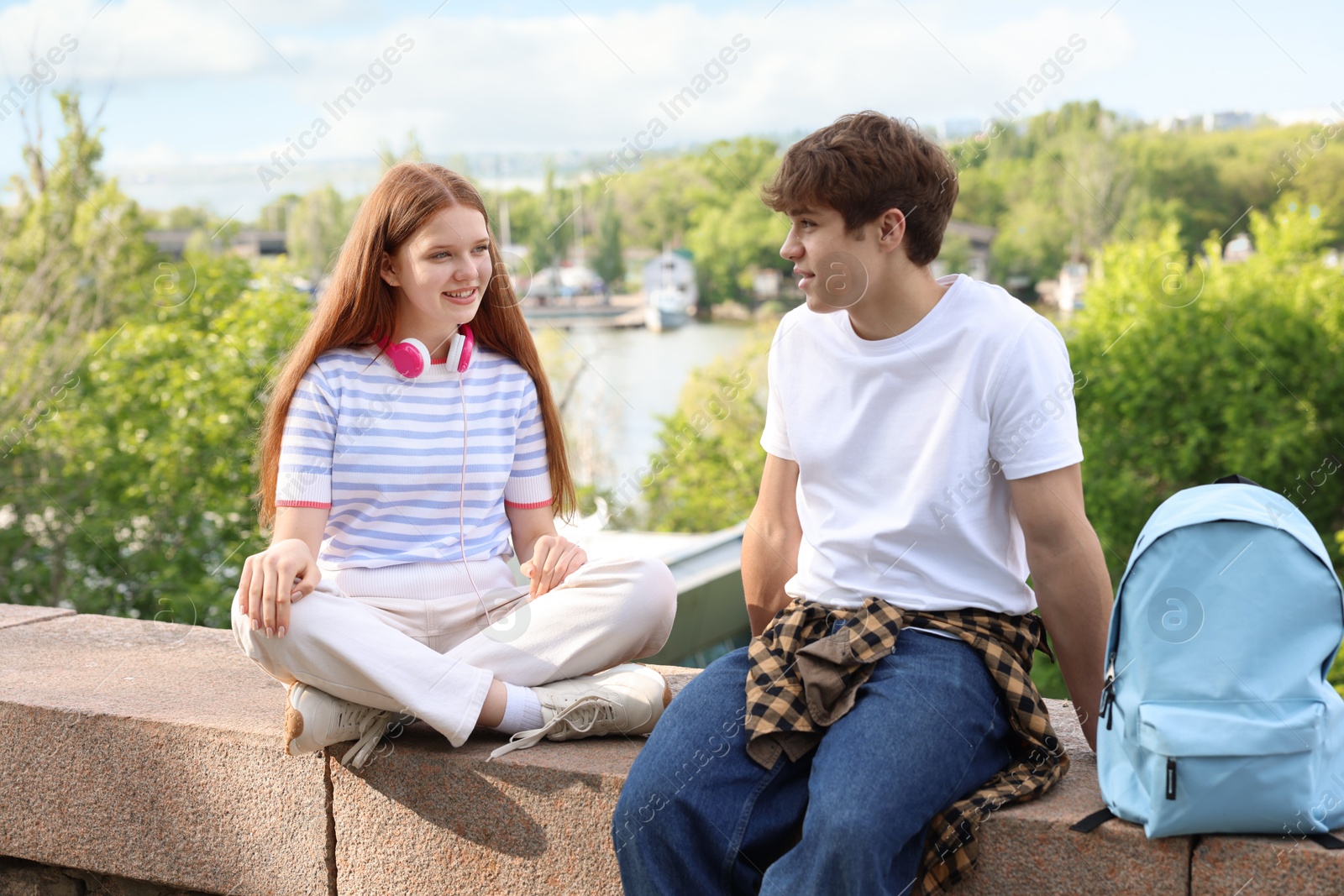 Teenage girl and boy spending time together outdoors Photo of Teenage girl and boy spending time together outdoors