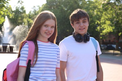 Photo of Teenage girl and boy walking together in park