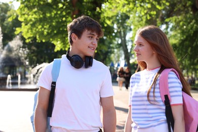 Photo of Teenage girl and boy walking together in park
