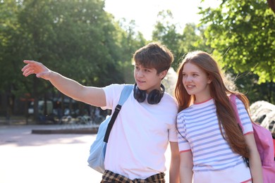 Photo of Teenage girl and boy walking together in park