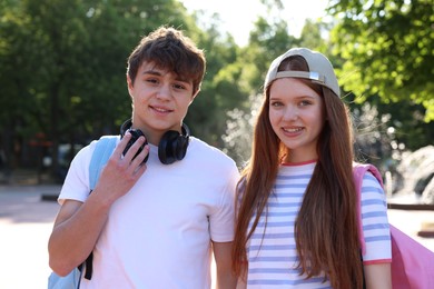 Photo of Teenage girl and boy walking together in park