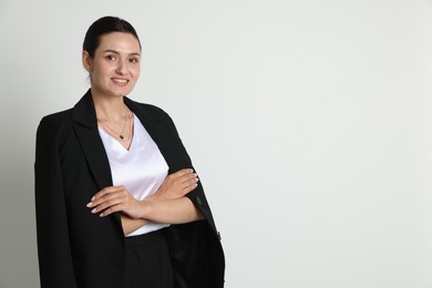 Photo of Confident business woman in suit on light background. Space for text