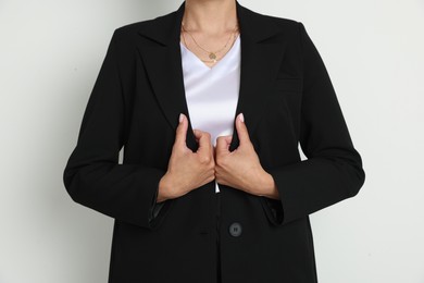 Photo of Confident business woman in suit on light background, closeup