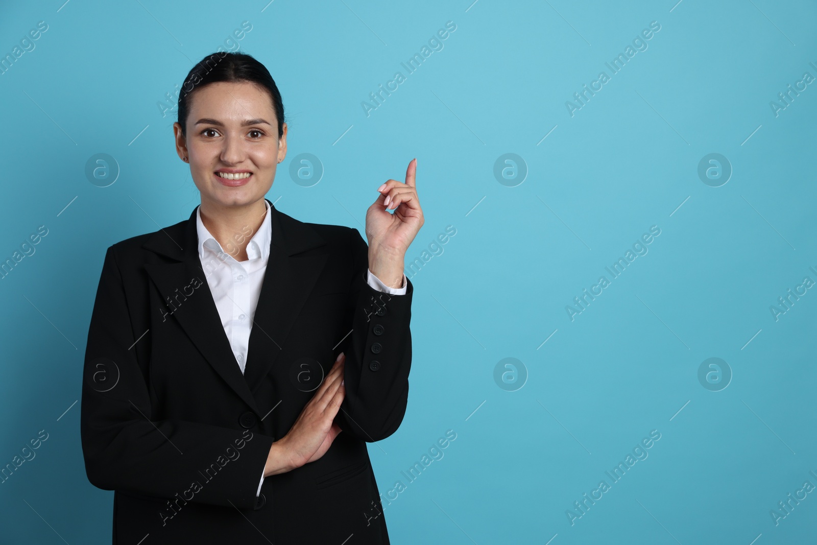 Confident business woman in suit on light blue background. Space for text Photo of Confident business woman in suit on light blue background. Space for text