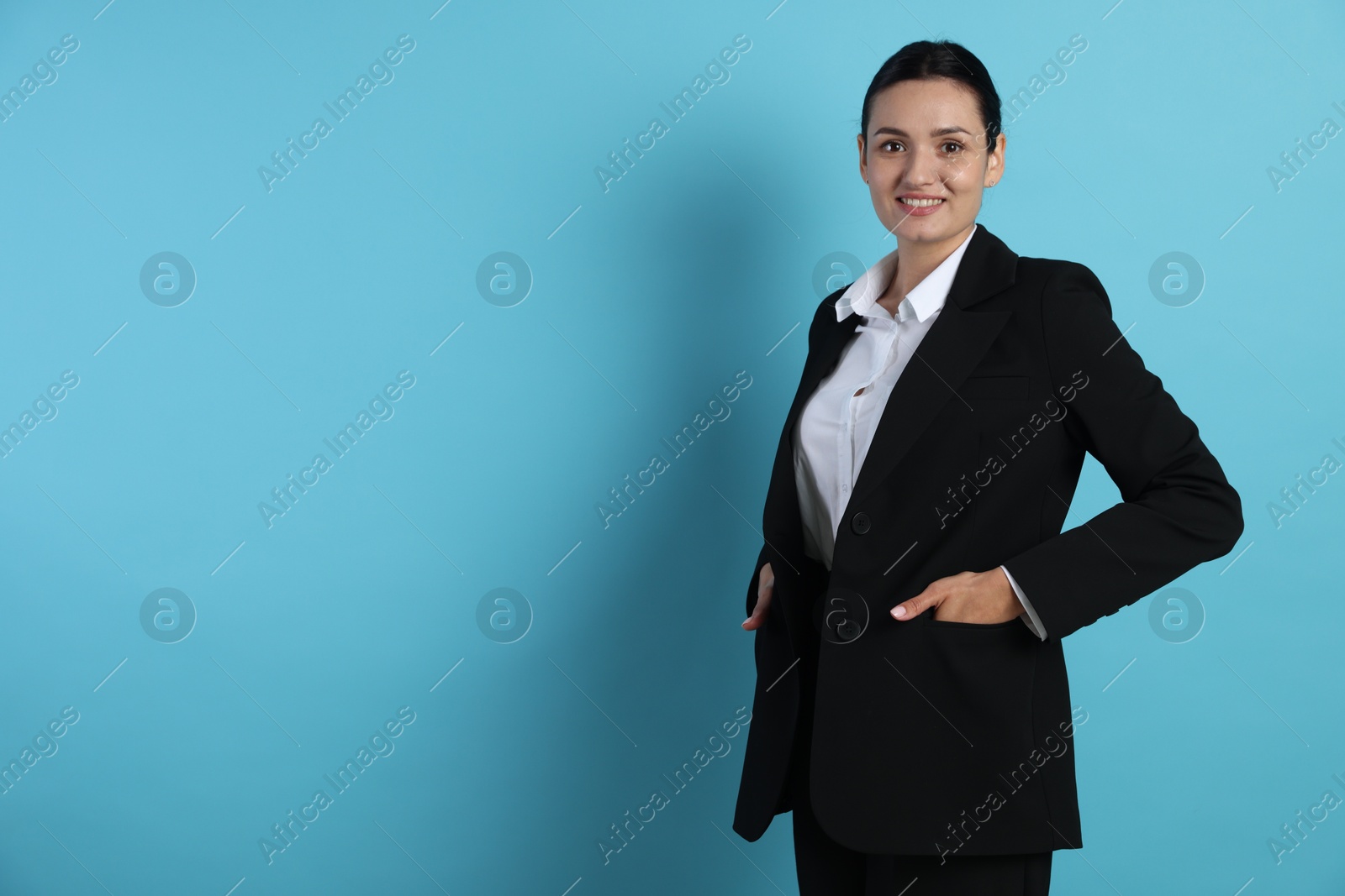 Confident business woman in suit on light blue background. Space for text Photo of Confident business woman in suit on light blue background. Space for text