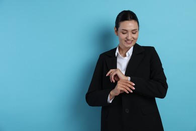 Photo of Confident business woman in suit on light blue background. Space for text