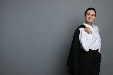 Photo of Confident business woman in suit on grey background. Space for text