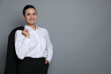 Photo of Confident business woman in suit on grey background. Space for text