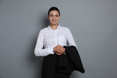 Photo of Confident business woman in suit on grey background