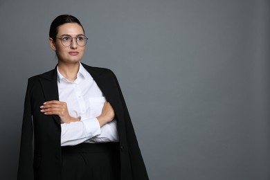 Photo of Confident business woman in suit on grey background. Space for text