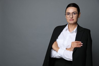 Photo of Confident business woman in suit on grey background. Space for text