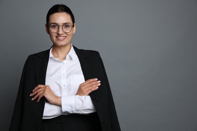 Photo of Confident business woman in suit on grey background. Space for text