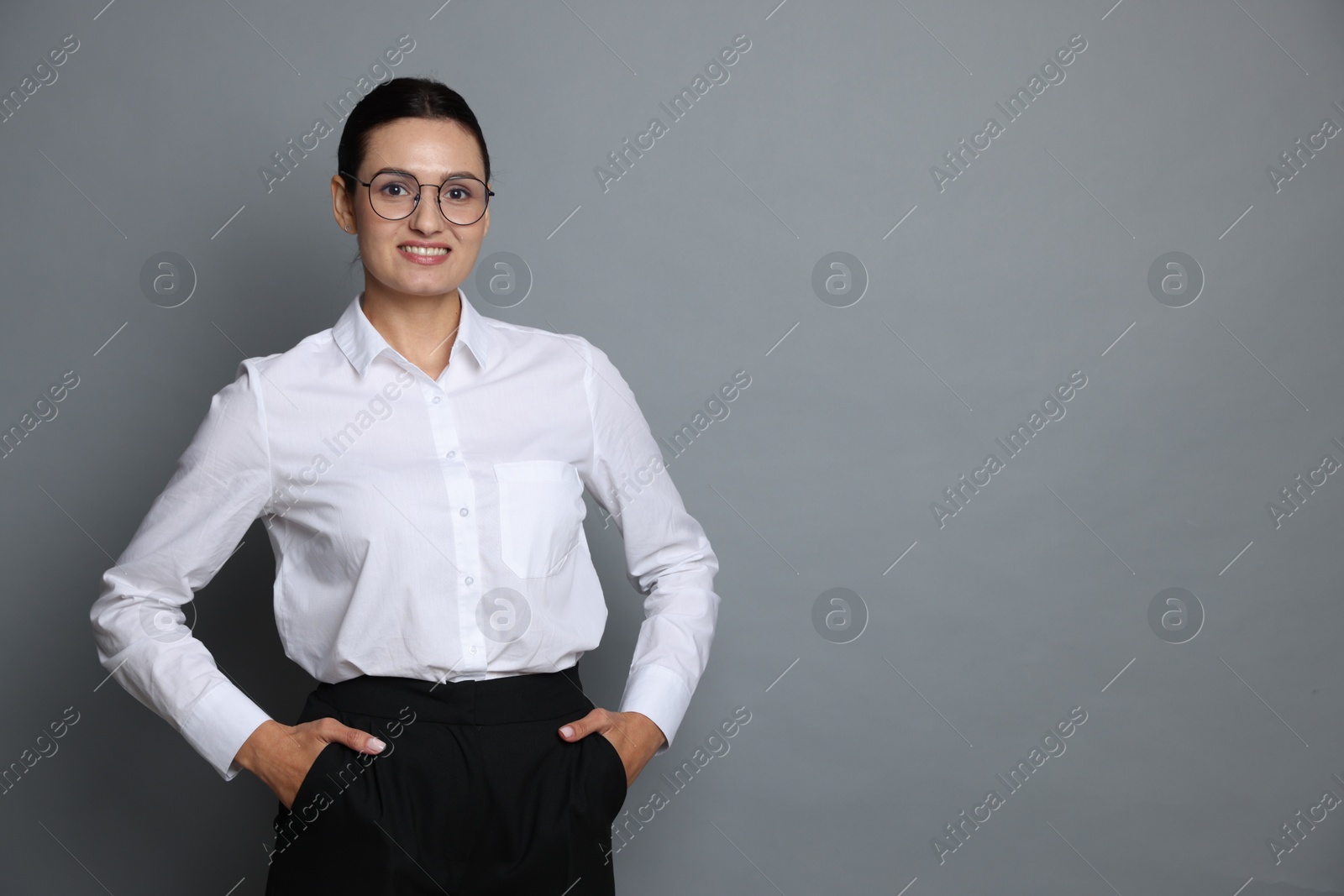 Portrait of confident business woman on grey background. Space for text Photo of Portrait of confident business woman on grey background. Space for text