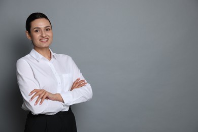 Photo of Portrait of confident business woman on grey background. Space for text