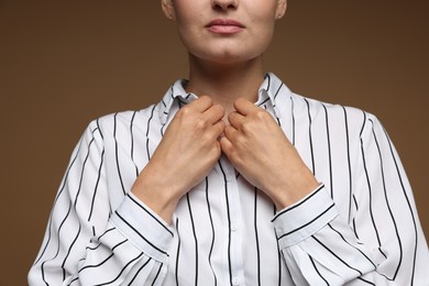 Photo of Confident business woman on brown background, closeup