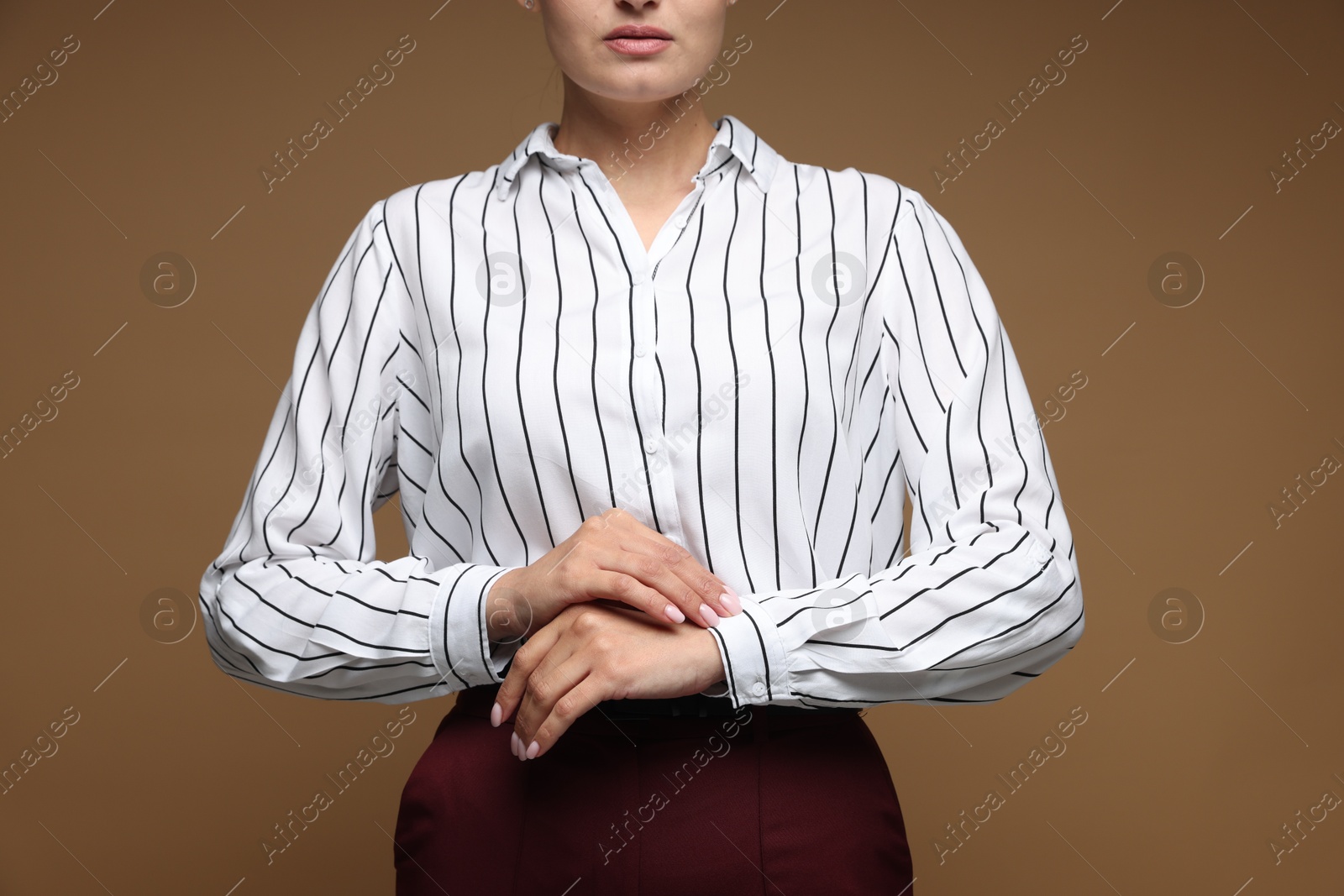 Confident business woman on brown background, closeup Photo of Confident business woman on brown background, closeup