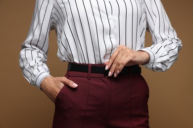 Photo of Confident business woman on brown background, closeup