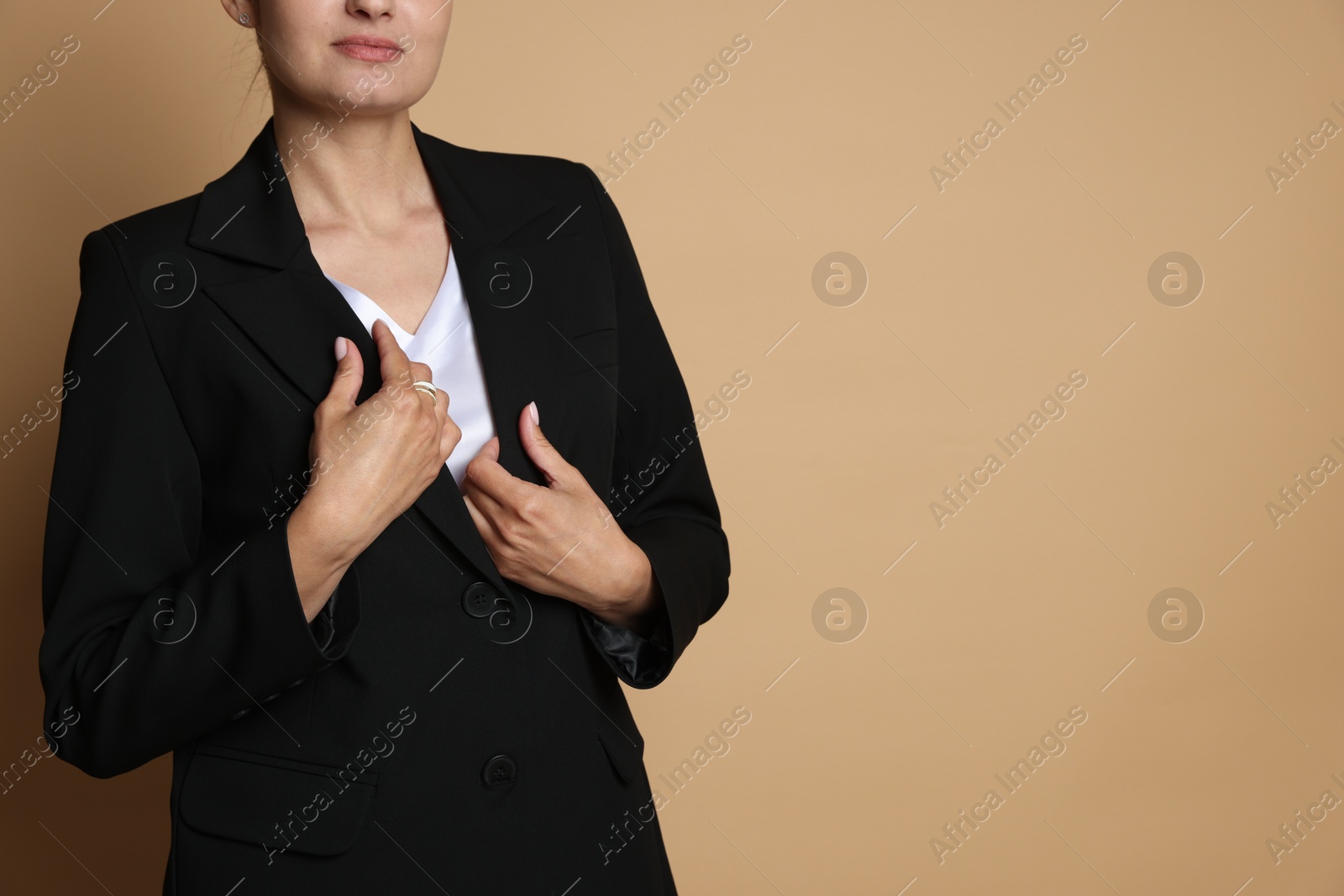 Confident business woman in suit on beige background, closeup. Space for text Photo of Confident business woman in suit on beige background, closeup. Space for text