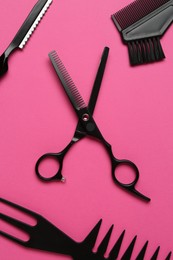 Photo of Different hairdresser's tools on pink background, flat lay